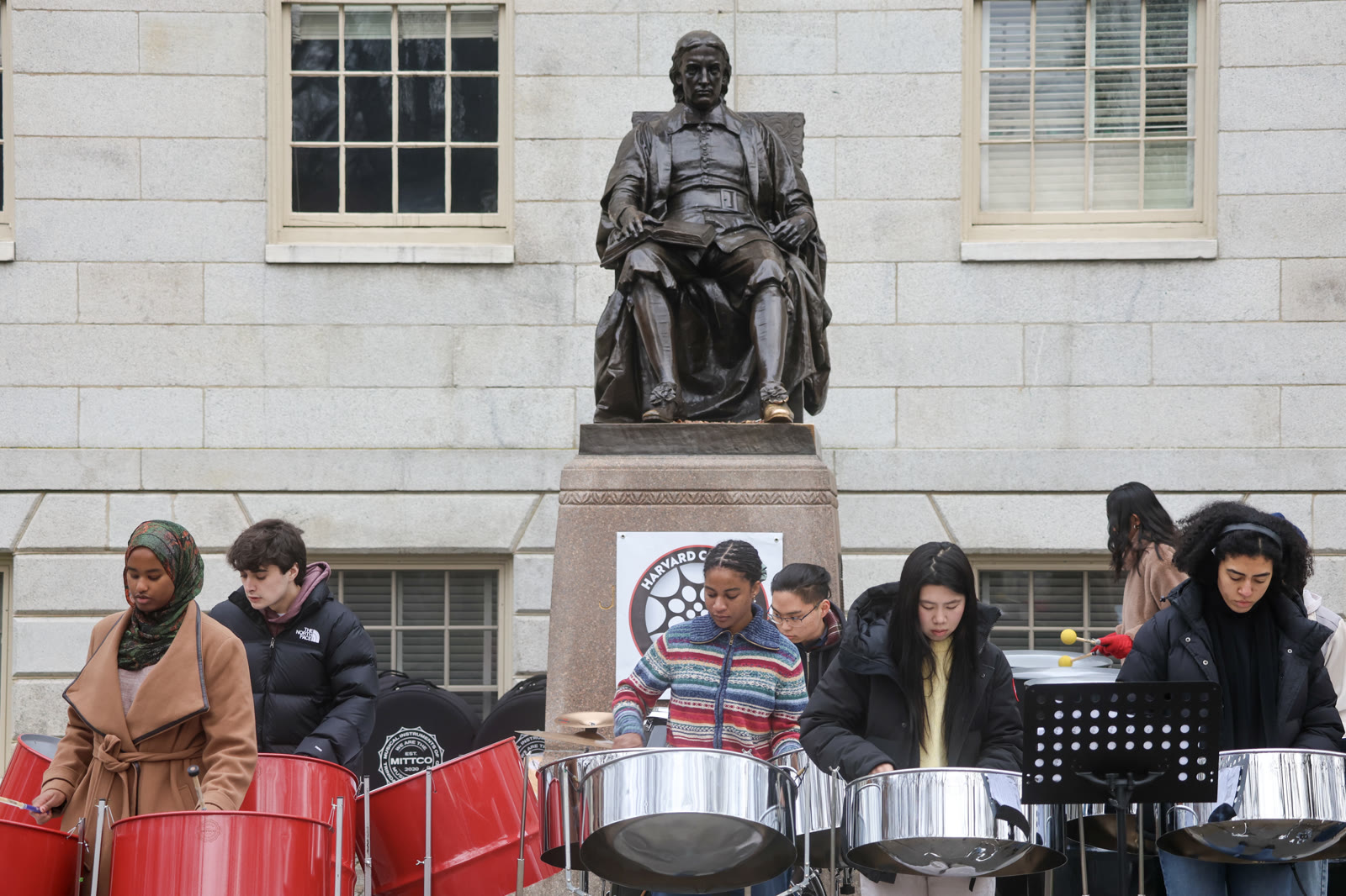 The ensemble performing beside the John Harvard statue during a fundraiser.
